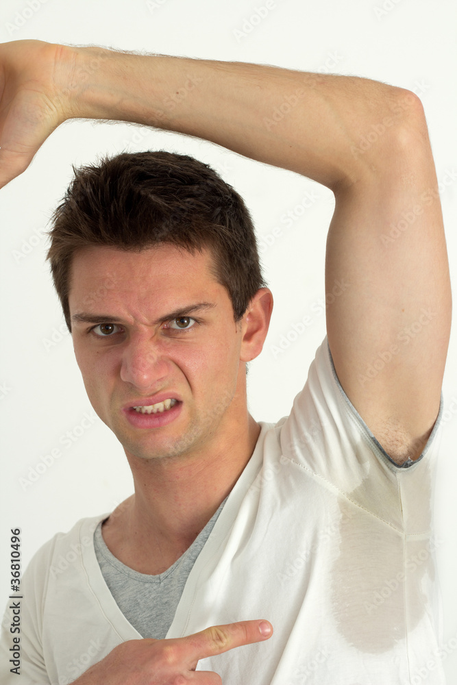 Man sweating very badly under armpit and pointing there Man sweating very badly under armpit and pointing there