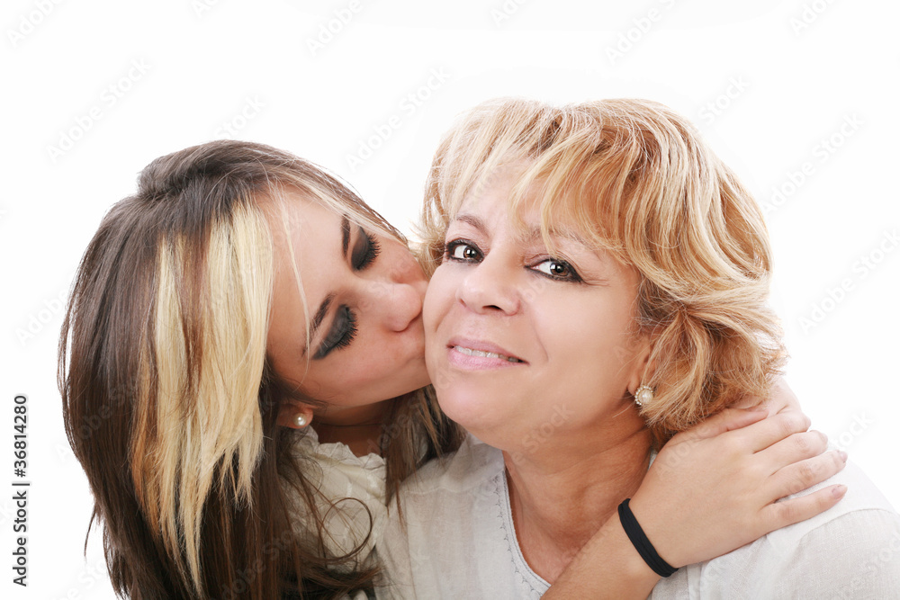 Closeup of young girl kissing her mom isolated on a white backgr Closeup of young girl kissing her mom isolated on a white backgr
