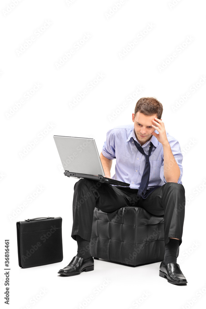 A disappointed businessman and his laptop A disappointed businessman and his laptop