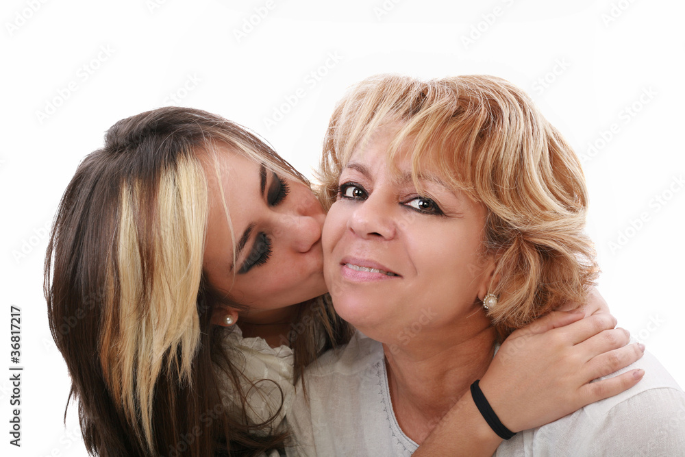 Closeup of young girl kissing her mom isolated on a white backgr Closeup of young girl kissing her mom isolated on a white backgr