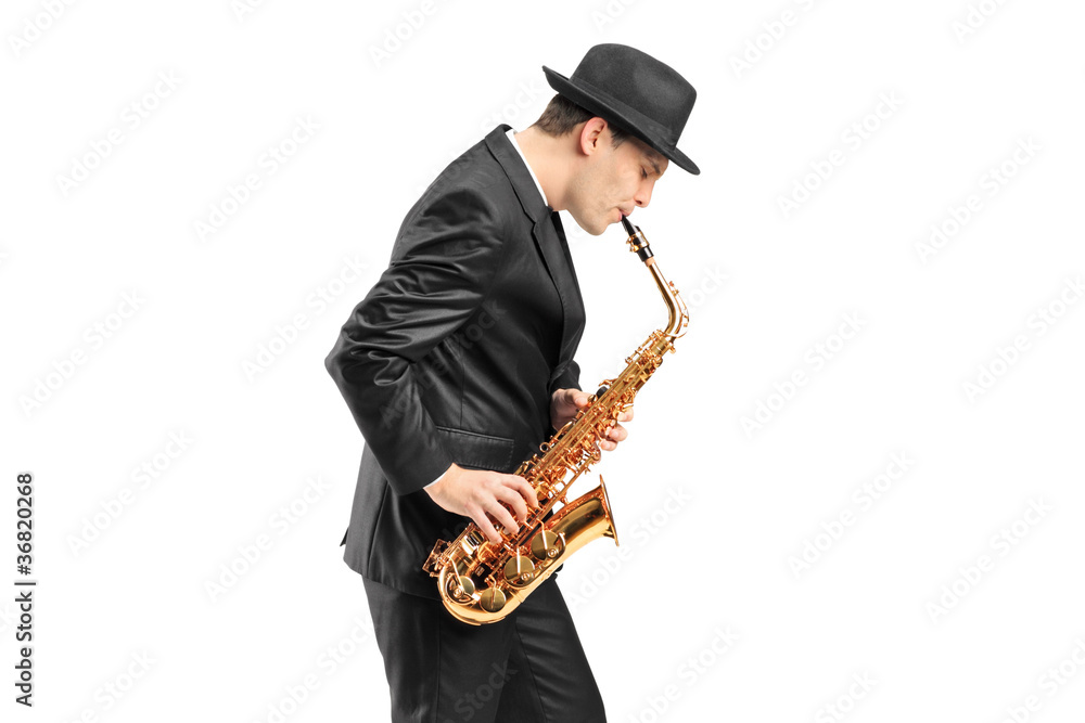 Naklejka premium A young man playing on saxophone