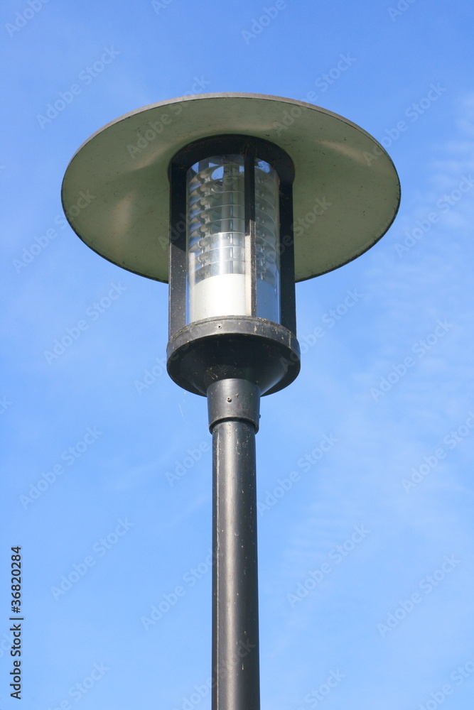 Street lamp with a large screen, blue sky in the background Street lamp with a large screen, blue sky in the background