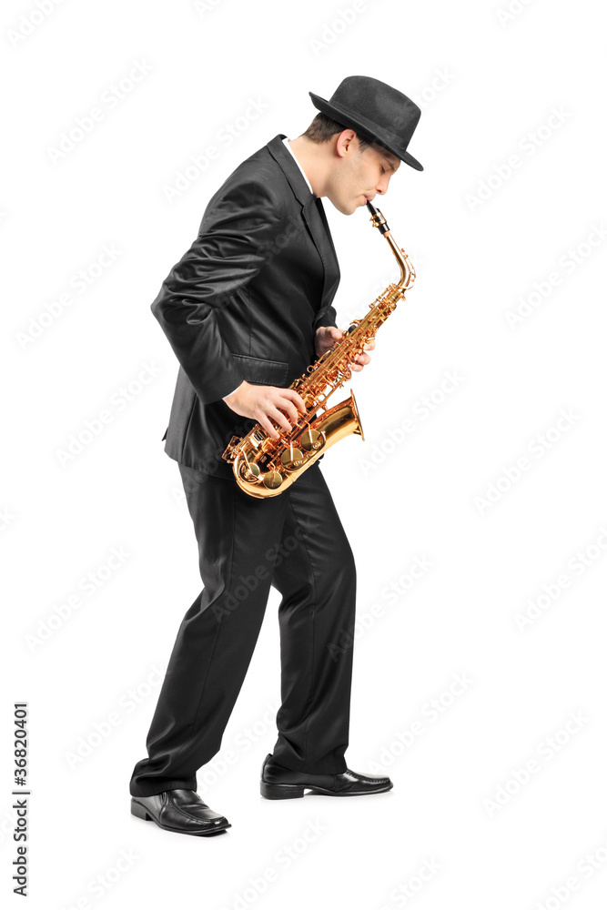 Naklejka premium Full length portrait of a young man playing on saxophone