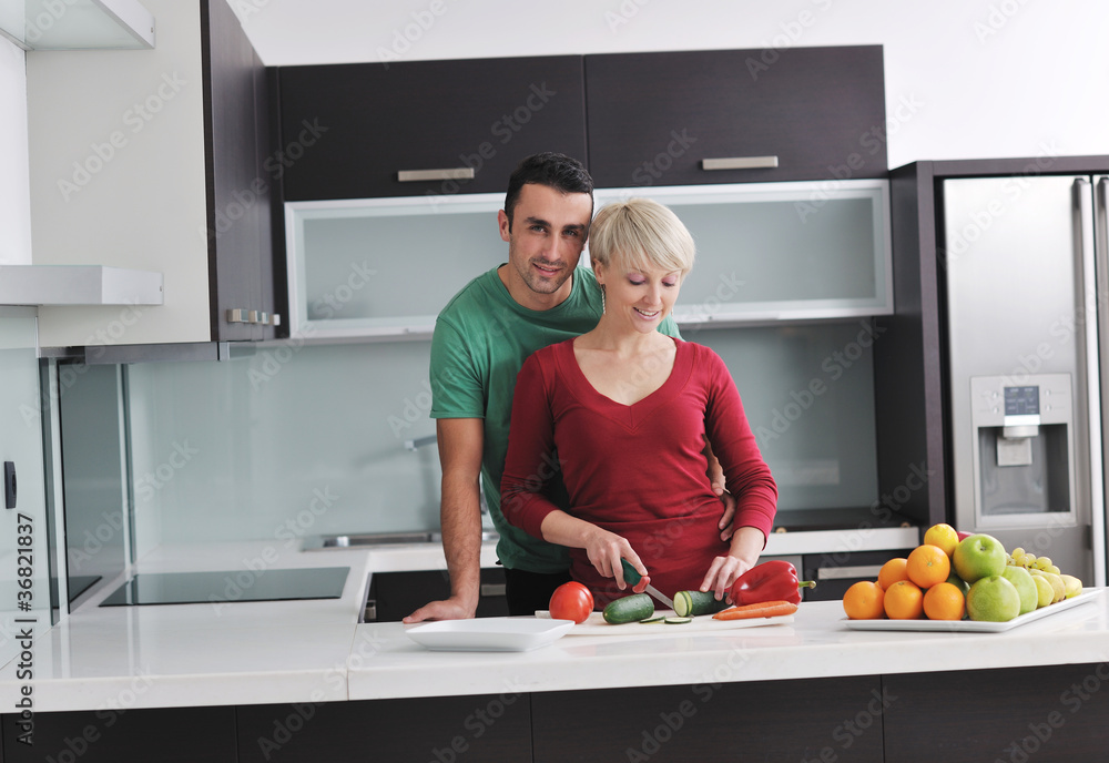 young couple have fun in modern kitchen young couple have fun in modern kitchen