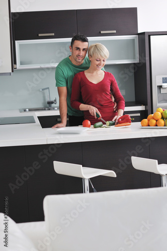 young couple have fun in modern kitchen