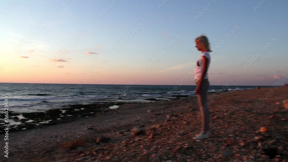 Girl jumping for joy watching the sunset on the beach Girl jumping for joy watching the sunset on the beach