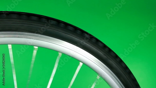 part of bicycle wheel fast rotating on chroma key
