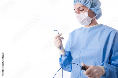 Female doctor or nurse holding a catheter photo