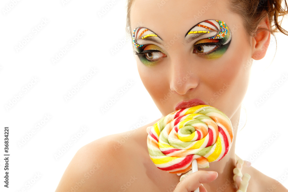woman licks candy with beautiful make-up isolated on white