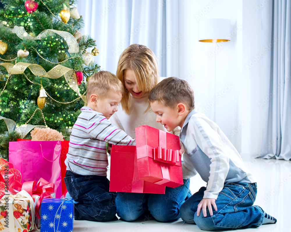 Children with Christmas gifts. Christmas tree Children with Christmas gifts. Christmas tree
