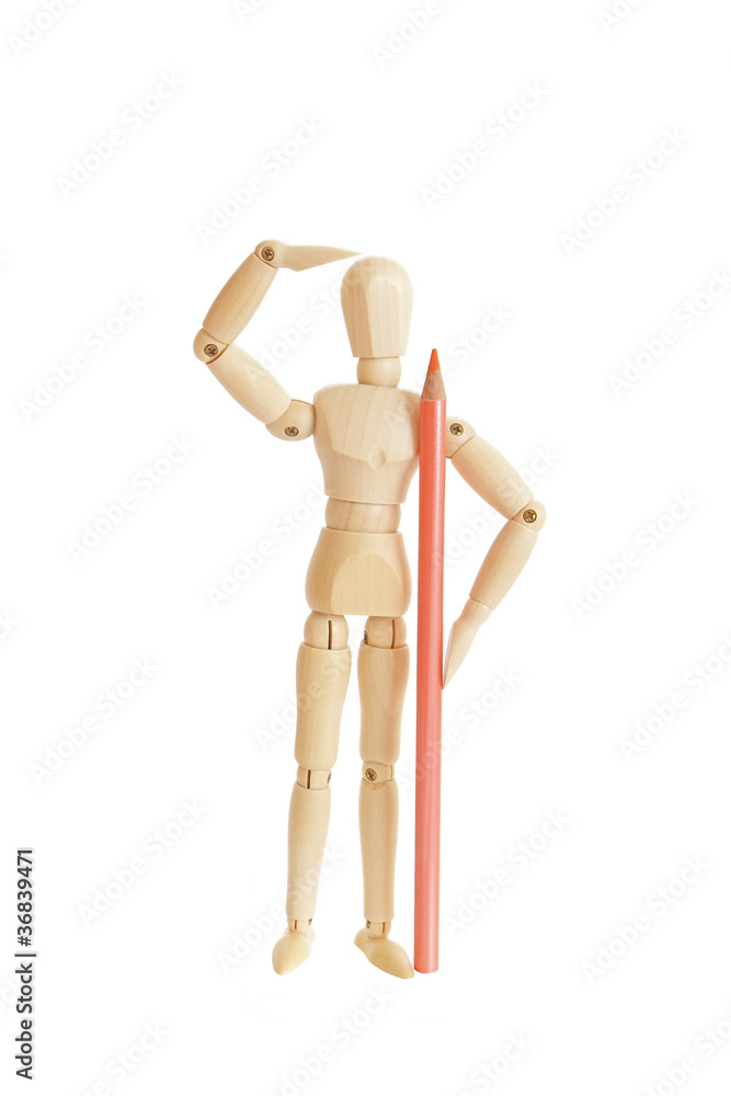 Wooden figure holding orange pencil and looking Wooden figure holding orange pencil and looking