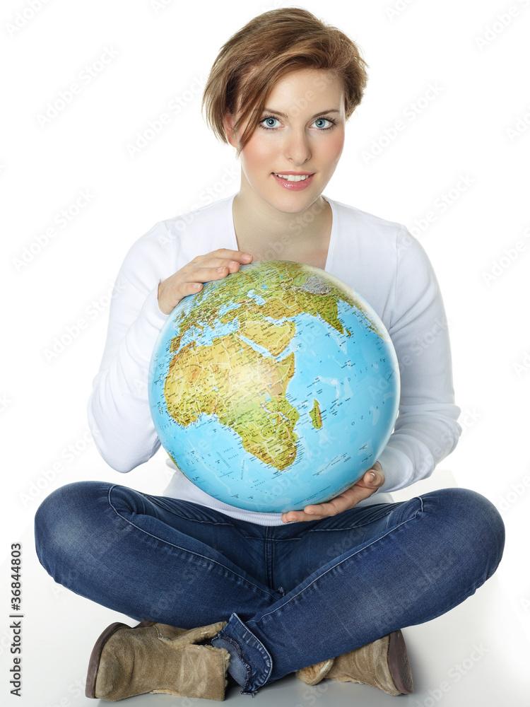 Woman sitting cross-legged on the floor and holding a globe Woman sitting cross-legged on the floor and holding a globe