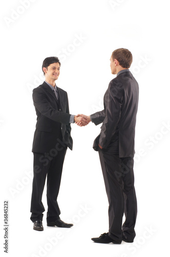 Two young and handsome businessmen shaking hands