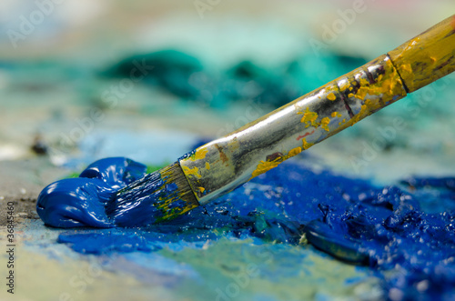 Paint brush and blue oil paint