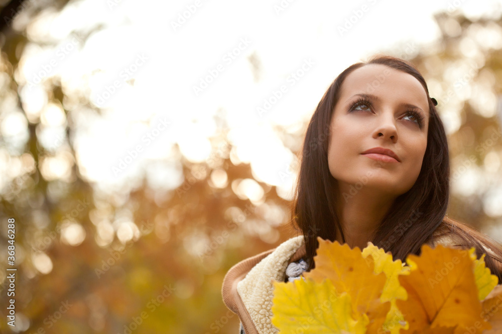 brunette holding autmun leaves brunette holding autmun leaves