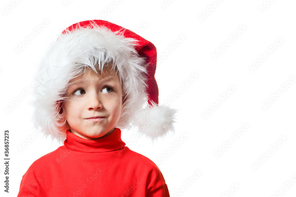 Boy in Santa Clause hat looking sideways Boy in Santa Clause hat looking sideways