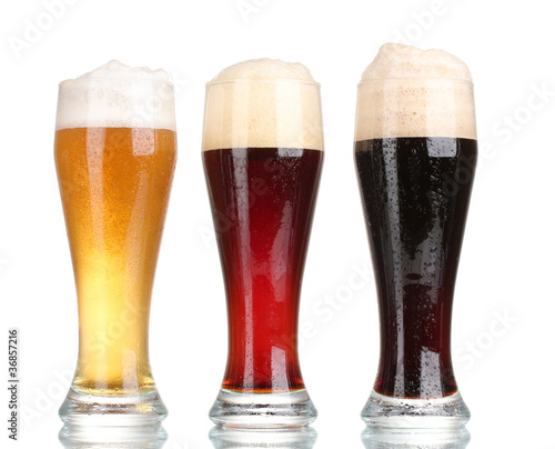 three glasses with different beers isolated on white