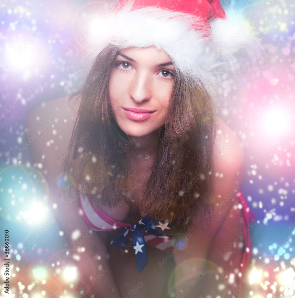 20-25 years old beautiful woman in christmas hat and swimsuit wi 20-25 years old beautiful woman in christmas hat and swimsuit wi