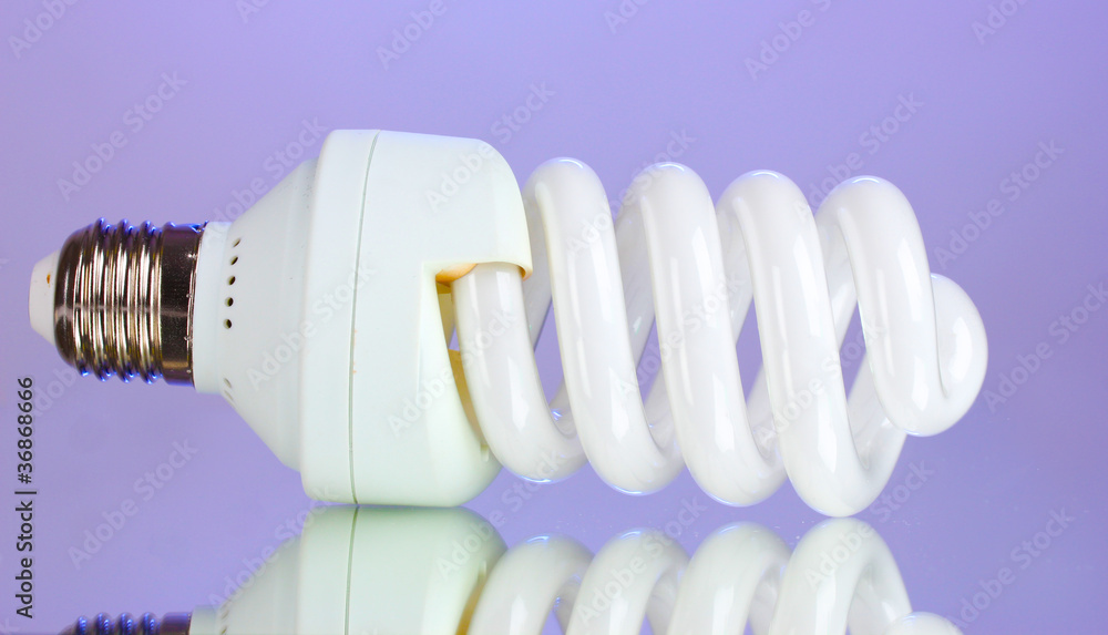 energy saving light bulb on purple background. energy saving light bulb on purple background.