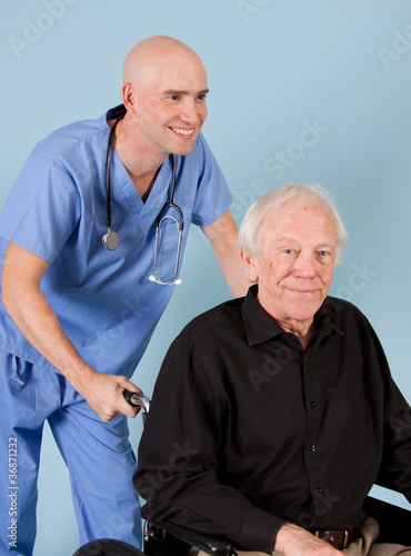 Medical worker pushing patient in wheechair.