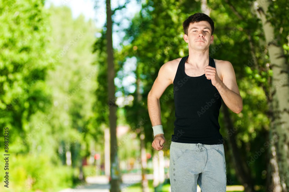 Young man jogging in park Young man jogging in park