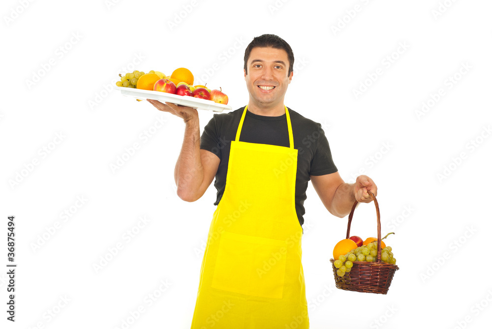Greengrocer holding plateau and basket with fruits Greengrocer holding plateau and basket with fruits