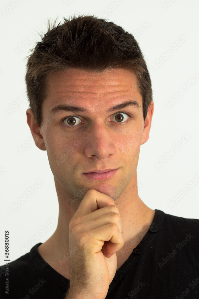 Man with hand on chin looking suprised and thinking Man with hand on chin looking suprised and thinking