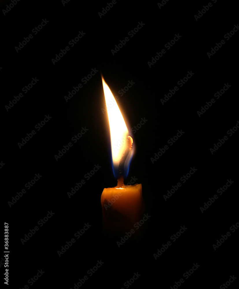 Closeup of burning candle isolated on black background. Closeup of burning candle isolated on black background.