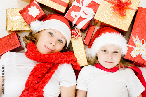 Happy Christmas mother and daughter with presents