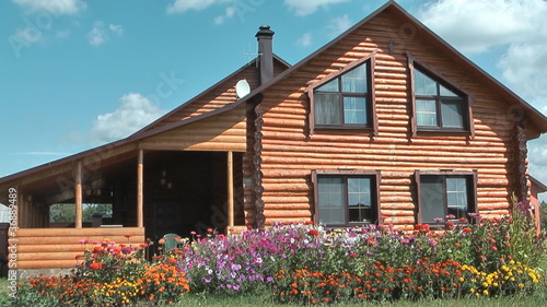 Country log house in the sunny summer day.