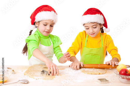 Two smiling girls with Christmas cooking