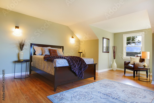 Fresh green bedroom with modern brown bed