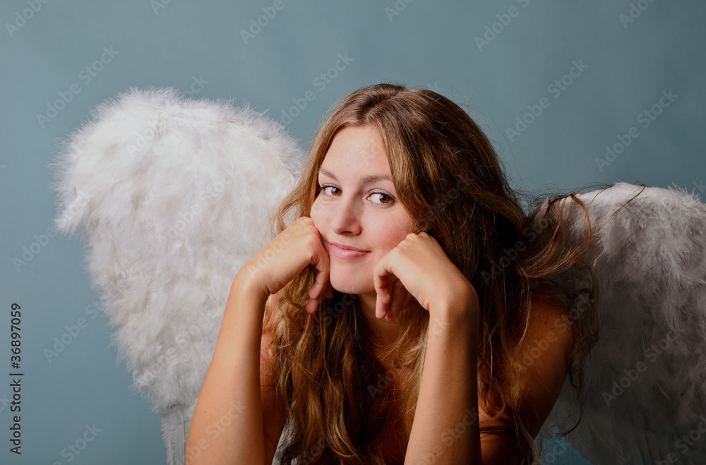 Christmas: Pleasant young angel with blue background Christmas: Pleasant young angel with blue background