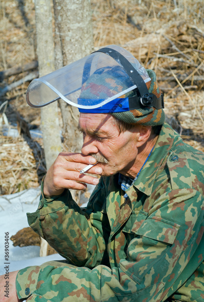 Worker smoking in forest 2