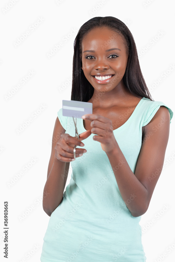 Happy smiling woman destroying her credit card Happy smiling woman destroying her credit card