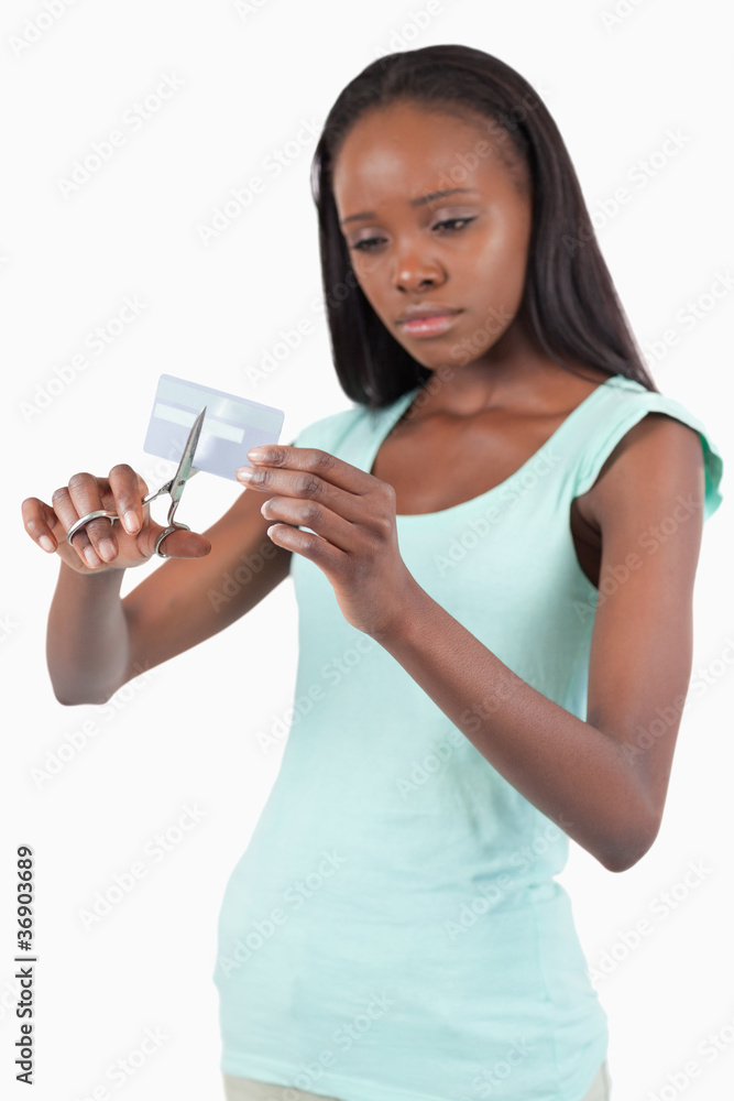 Sad looking female destroying her credit card Sad looking female destroying her credit card