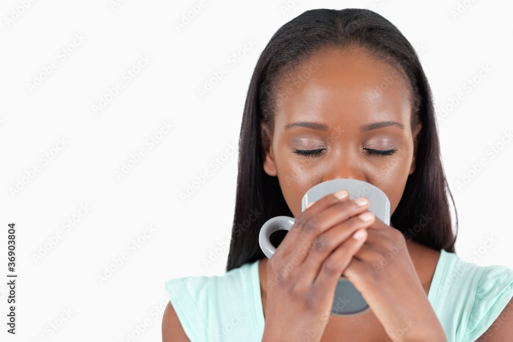 Young woman relaxing with a cup of coffee Young woman relaxing with a cup of coffee