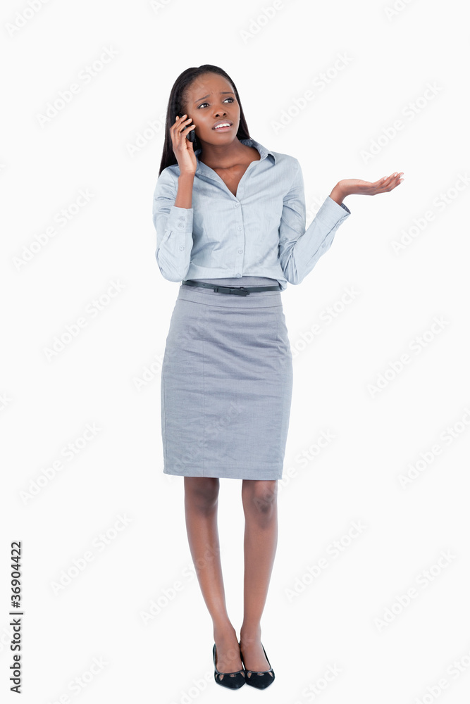 Portrait of a confused businesswoman making a phone call Portrait of a confused businesswoman making a phone call