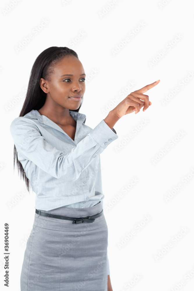Portrait of a young businesswoman pressing an invisible key Portrait of a young businesswoman pressing an invisible key