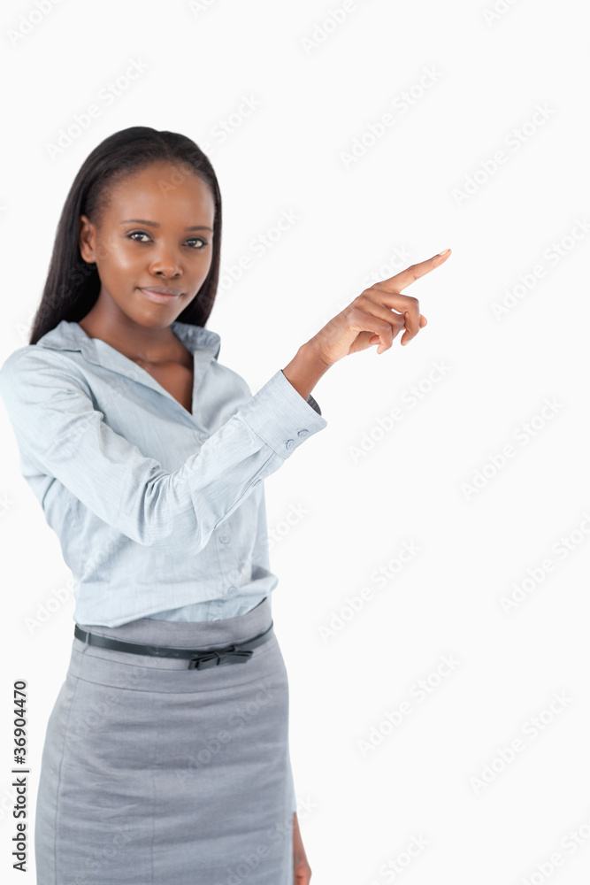 Portrait of a cute businesswoman pressing an invisible key Portrait of a cute businesswoman pressing an invisible key