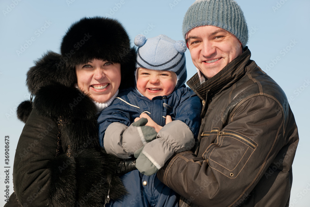 Cheerful family of three on winter walk Cheerful family of three on winter walk