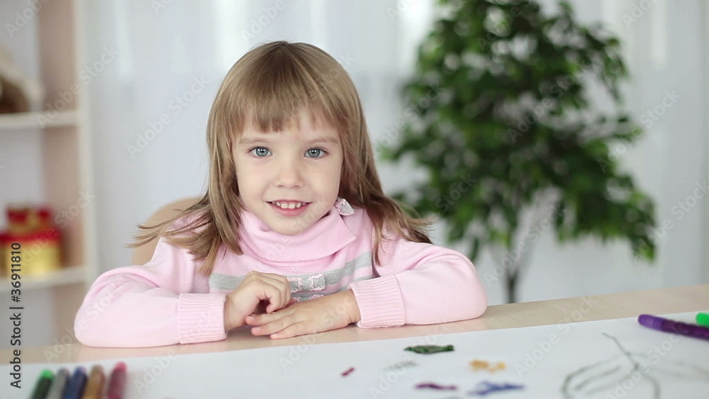 Girl with folded hands looking at camera Girl with folded hands looking at camera