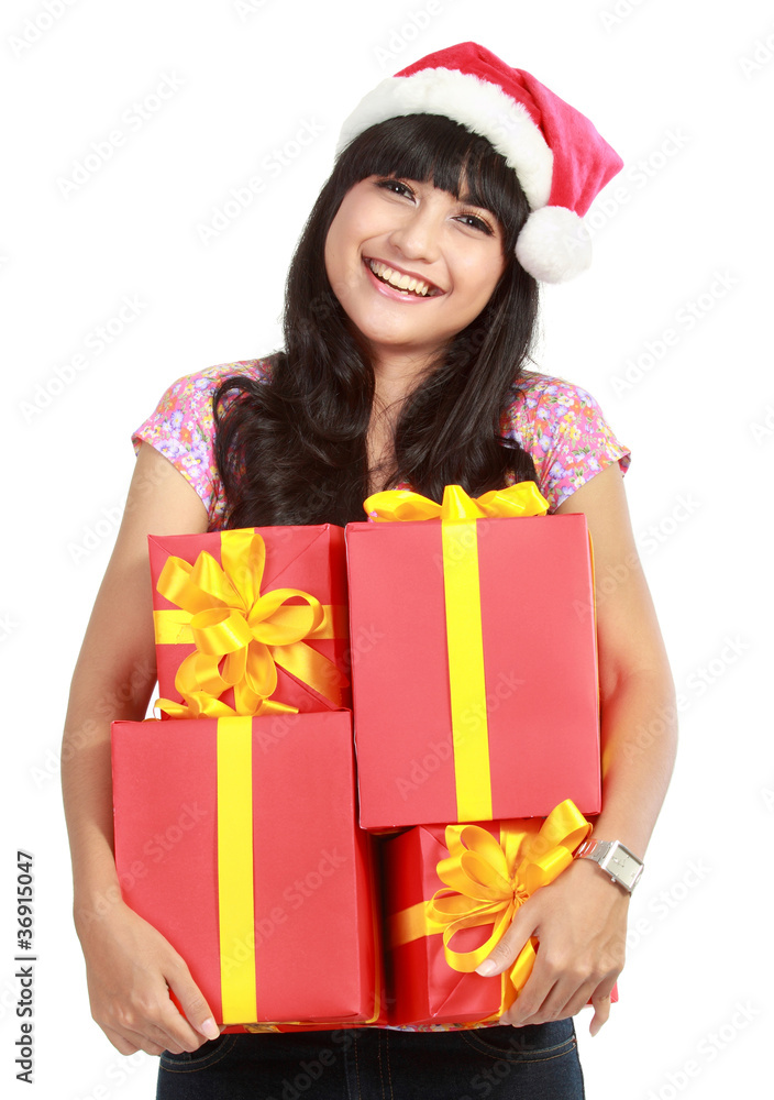 Christmas woman holding gifts wearing Santa hat Christmas woman holding gifts wearing Santa hat
