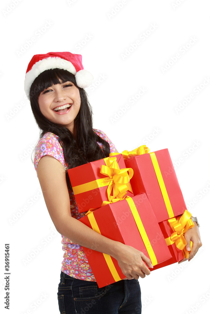 woman in Santa hat holding Christmas gifts woman in Santa hat holding Christmas gifts