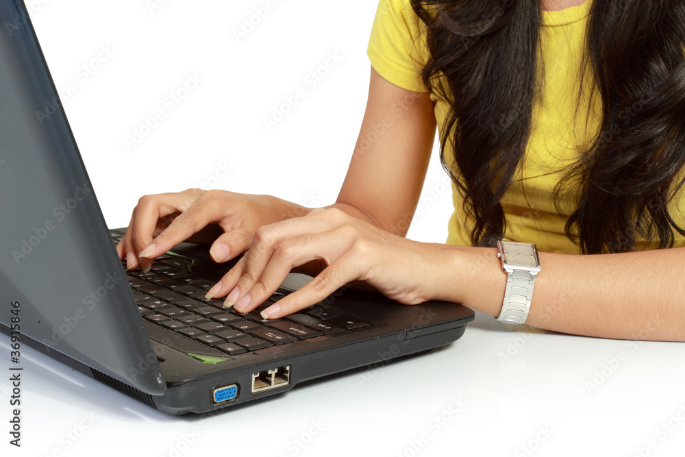 Naklejka premium Cut image of female hand working on a laptop