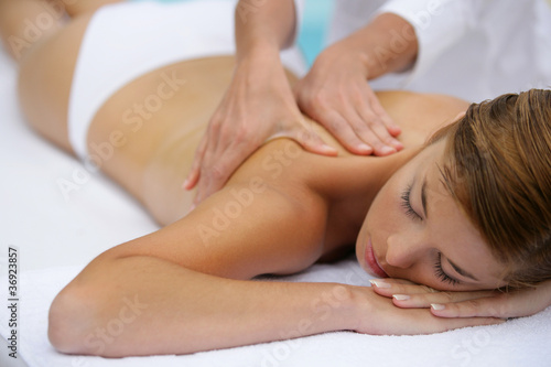 Attractive young woman unwinding with back massage