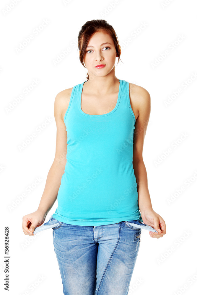Young teenage girl standing and showing her empty pockets. Young teenage girl standing and showing her empty pockets.