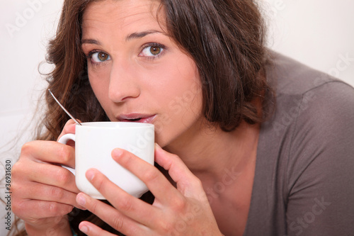 Woman sipping a hot drink