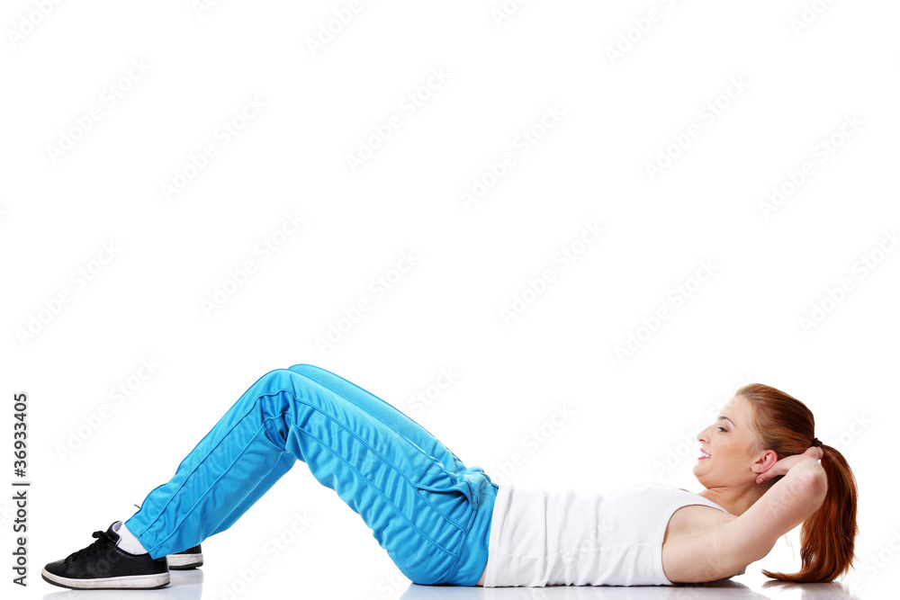 Teen student doing exercises on the floor. Teen student doing exercises on the floor.