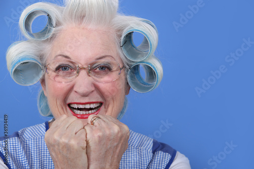 senior woman with curlers in her hair laughing